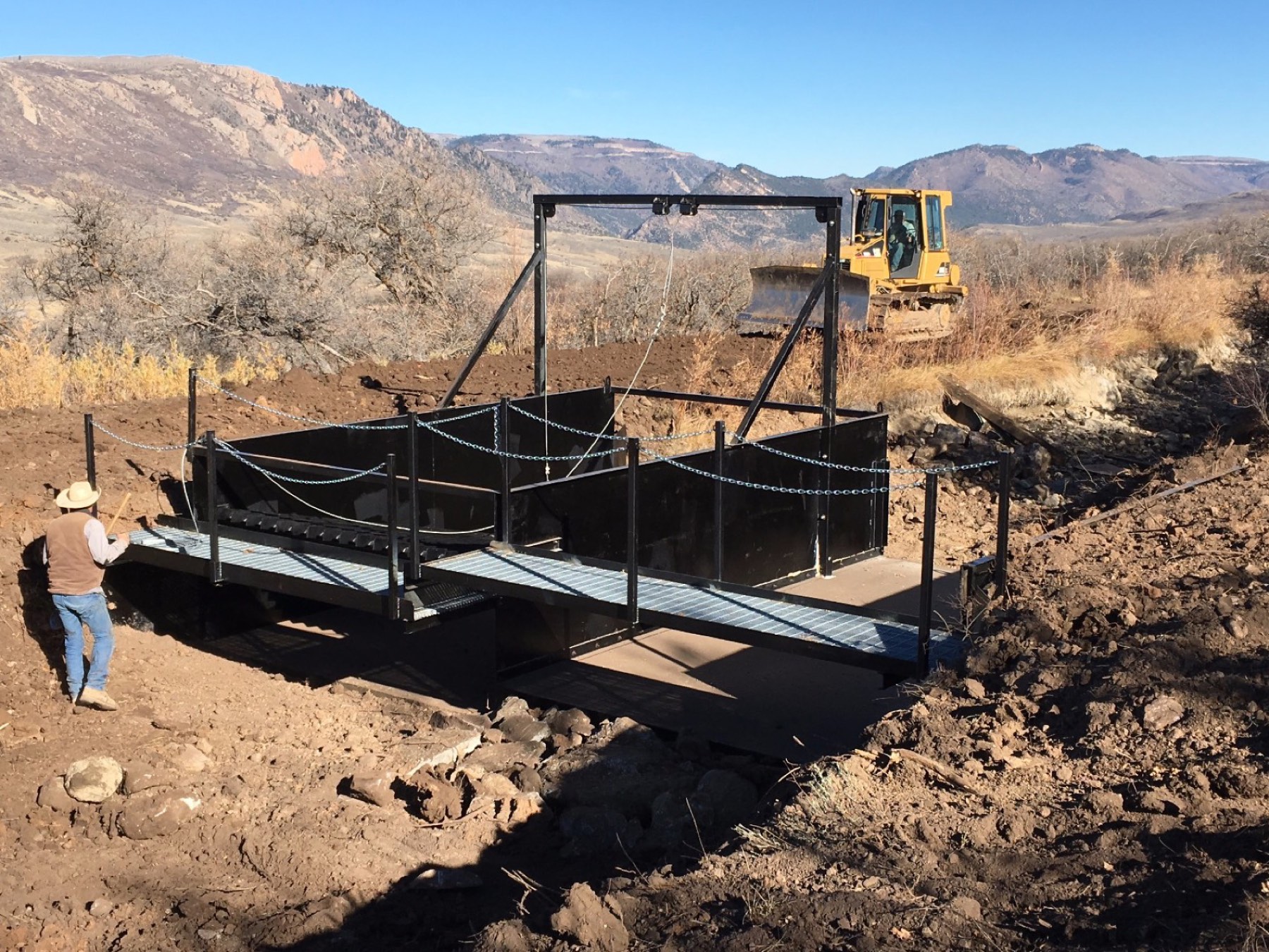 A custom steel platform and walkway, fabricated by Ag-Fab and installed on a remote western Colorado job site